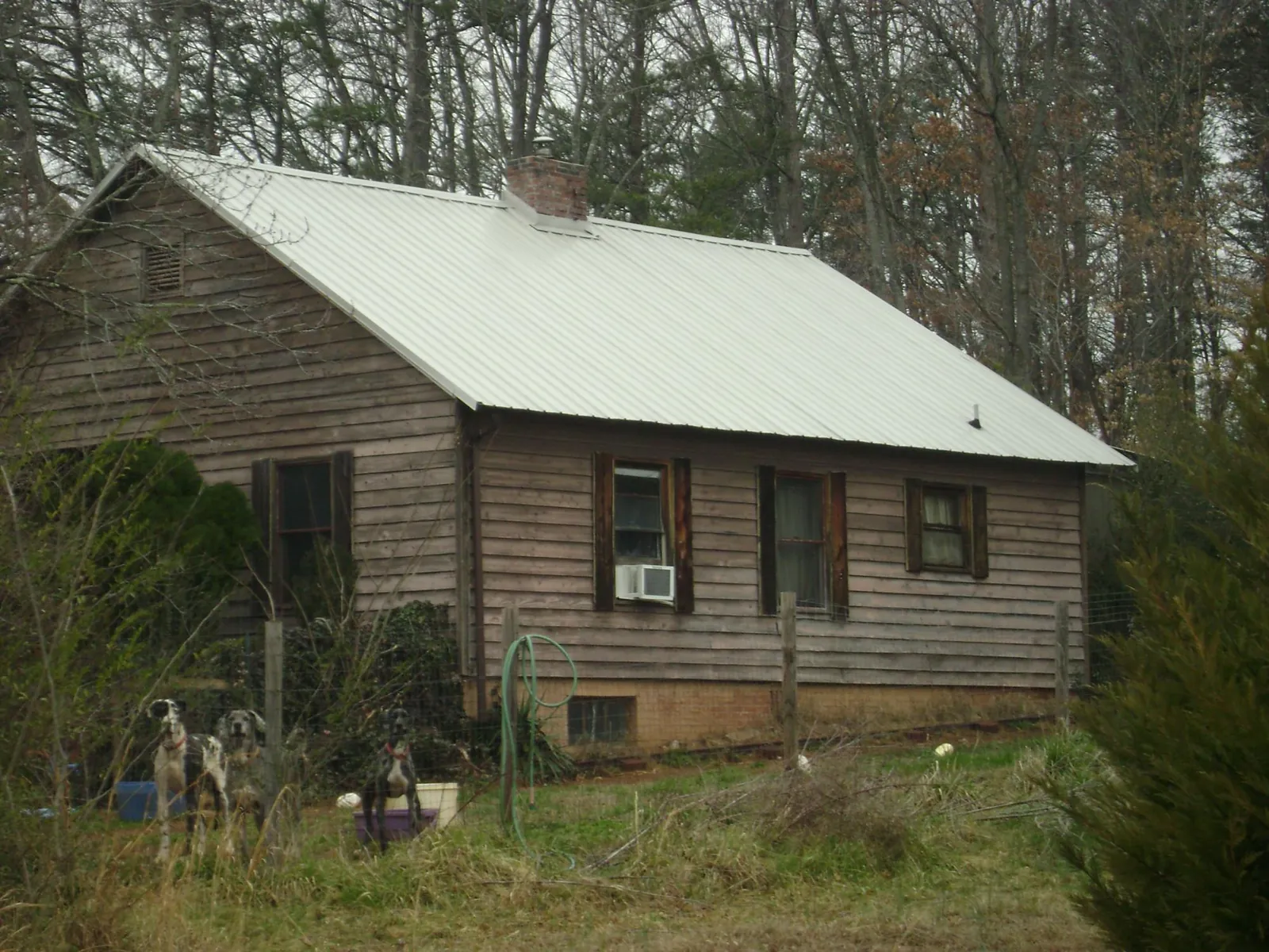 White metal roof on an old wood sided farmhouse, from a Metal Roof Installation job in Waseca
